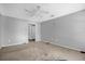 Spacious carpeted bedroom with ceiling fan and neutral walls at 3954 Versailles Dr # 3954B, Orlando, FL 32808