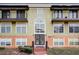 Building exterior featuring a classic design, double door entry, and balconies at 3954 Versailles Dr # 3954B, Orlando, FL 32808
