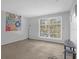 Spacious living room with large window and carpeted floor at 3954 Versailles Dr # 3954B, Orlando, FL 32808