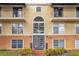 Condo building exterior featuring multiple balconies and a grand entrance at 3995 Versailles Dr # 3995F, Orlando, FL 32808