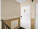 Condo building interior entryway with white door and neutral walls at 3995 Versailles Dr # 3995F, Orlando, FL 32808