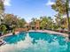 Inviting community pool with a fireplace and hot tub at 4008 Versailles Dr # 4008C, Orlando, FL 32808