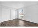 Well-lit bedroom featuring wood-look floors and a large window at 4038 Versailles Dr # 4038 C, Orlando, FL 32808