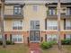 Inviting condo building entrance with landscaping at 4121 Dijon Dr # 4121H, Orlando, FL 32808