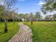 Brick pathway meanders through green lawn at 4121 Dijon Dr # 4121H, Orlando, FL 32808