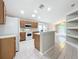 Kitchen with island, white appliances, and view to living room at 425 Tree Shore Dr, Orlando, FL 32825