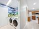 Laundry room with washer, dryer and painted mural at 425 Tree Shore Dr, Orlando, FL 32825