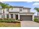 Two-story house with a two-car garage and landscaping at 4501 Monado Dr, Kissimmee, FL 34746