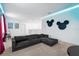 Home theater with sectional sofa and Mickey Mouse decor at 4501 Monado Dr, Kissimmee, FL 34746