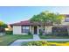 Inviting exterior of a condo with a tiled roof, landscaping, and a walkway at 547 Hunter Cir # 547, Kissimmee, FL 34758
