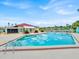 Community pool with surrounding patio furniture at 547 Hunter Cir # 547, Kissimmee, FL 34758