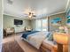 Main bedroom with wood floors, ceiling fan, and sliding glass doors leading to the backyard at 560 Lake Mills Rd, Chuluota, FL 32766