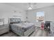 Bedroom with grey bedding, desk workspace and wood-look flooring at 7645 Fordson Ln, Windermere, FL 34786