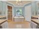 Elegant bathroom with soaking tub, walk-in shower, and dual vanities at 9664 Weatherstone Ct, Windermere, FL 34786