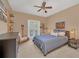 Bedroom with double bed, access to balcony, and nautical decor at 9664 Weatherstone Ct, Windermere, FL 34786