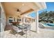 Covered patio with dining table and chairs, perfect for outdoor meals at 9664 Weatherstone Ct, Windermere, FL 34786