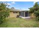 Landscaped backyard with a screened porch and AC unit at 10637 Deergrass Ln, Orlando, FL 32821