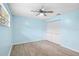 Light and airy bedroom with wood-look tile floors and ceiling fan at 10637 Deergrass Ln, Orlando, FL 32821
