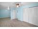 Spacious bedroom with light blue walls and wood-look tile floors at 10637 Deergrass Ln, Orlando, FL 32821