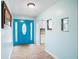Bright entryway with teal door, tile floors, and view of kitchen at 10637 Deergrass Ln, Orlando, FL 32821