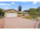 House exterior showcasing a brick driveway and attached garage at 10637 Deergrass Ln, Orlando, FL 32821