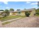 Ranch style home with brick paver driveway and palm trees at 10637 Deergrass Ln, Orlando, FL 32821