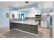 Modern kitchen with granite countertops and mosaic backsplash at 10637 Deergrass Ln, Orlando, FL 32821