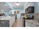 Modern kitchen with granite countertops and stainless steel appliances at 10637 Deergrass Ln, Orlando, FL 32821