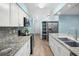 Bright kitchen featuring granite countertops and white cabinets at 10637 Deergrass Ln, Orlando, FL 32821