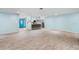 Spacious living room with light blue walls and wood-look tile floors at 10637 Deergrass Ln, Orlando, FL 32821