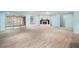 Spacious living room with corner fireplace and wood-look tile floors at 10637 Deergrass Ln, Orlando, FL 32821
