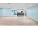 Open living area with light blue walls and tile flooring at 10637 Deergrass Ln, Orlando, FL 32821