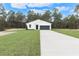 White house with black garage door and landscaping at 12386 Sw 89Th St, Dunnellon, FL 34432