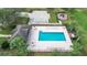 Aerial view of community pool, deck chairs, and cabana at 12529 Hammock Pointe Cir, Clermont, FL 34711