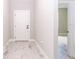 Interior view of entryway with white door and tile flooring at 12662 Sw 62Nd Pl, Ocala, FL 34481