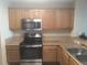 Kitchen with stainless steel appliances and wood cabinets at 13427 Blue Heron Beach Dr # 1103, Orlando, FL 32821