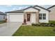 Charming single-story home with a white exterior, stone accents, and a two-car garage at 1418 Arbor Hill Dr, Deltona, FL 32725