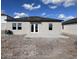 Rear view of a single-story house with a patio at 1425 Arbor Hill Dr, Deltona, FL 32725