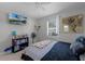 Spacious bedroom with a large TV, built-in shelving, and ample natural light at 15 Volusia Dr, Debary, FL 32713