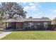 Ranch style home with carport, stone accents, and a well-maintained lawn at 15 Volusia Dr, Debary, FL 32713