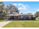 Gray house with a stone facade and driveway at 15 Volusia Dr, Debary, FL 32713