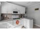 White kitchen with ample counter space and window view at 15 Volusia Dr, Debary, FL 32713