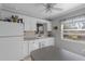Kitchen with white cabinets, a dishwasher, and a window at 15 Volusia Dr, Debary, FL 32713