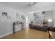Living room with hardwood floors, a brown couch, and gallery wall at 15 Volusia Dr, Debary, FL 32713