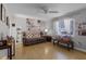 Bright living room featuring hardwood floors, a brown couch, and large artwork at 15 Volusia Dr, Debary, FL 32713