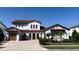 Two-story house with tile roof, three car garage, and landscaped front yard at 15511 Shorebird Ln, Winter Garden, FL 34787