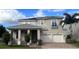 Two-story house with a neutral color palette and a three-car garage at 15721 Shorebird Ln, Winter Garden, FL 34787