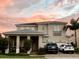 Two-story house with a neutral color palette and a three-car garage at 15721 Shorebird Ln, Winter Garden, FL 34787