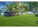 Spacious backyard with lush grass and mature trees at 20 Maynard Ave, Orlando, FL 32803