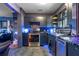 Modern dark kitchen with stainless steel appliances and blue LED lighting at 20 Maynard Ave, Orlando, FL 32803